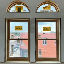 Close up of the arched double windows present in third-floor rooms of Hotel Garber.