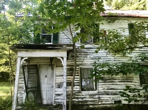 the birthplace home of Willa Cather. unstable white house with door half off hinges.