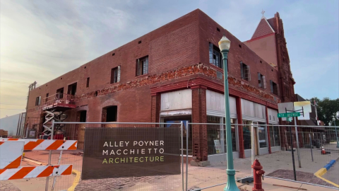 Street view of the Potter Block with construction fencing surrounding the brick structure